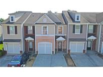 Charming townhome showcasing a well-maintained exterior with integrated garage and inviting front entrance at 3165 Creston Park Ct, Duluth, GA 30096