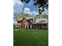 Charming two-story brick home with a well-manicured lawn and mature trees at 160 Eastlake Nw Pt, Kennesaw, GA 30144
