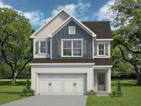 Charming two-story home with a three-car garage, lush lawn, and inviting curb appeal at 2975 Jefferson St, Austell, GA 30106
