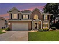 Charming two-story home with a well-maintained lawn and traditional architectural details at 1900 Green Oak Cir, Lawrenceville, GA 30043
