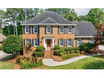 Charming brick home features a well-maintained yard and classic architectural details at 5004 Haralson Sw Way, Lilburn, GA 30047