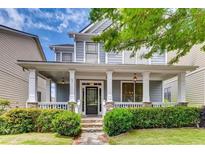 Charming two-story home with a welcoming front porch, stone accents, and beautiful landscaping at 1604 Gilstrap Nw Ln, Atlanta, GA 30318