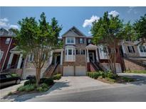 Charming townhome exterior featuring well-maintained landscaping and inviting entrances at 1622 Rivergreen Se Bnd # 26, Atlanta, GA 30339