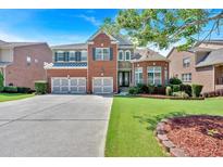 Beautiful brick home featuring a three-car garage and well-manicured lawn at 3819 Courson St, Marietta, GA 30066