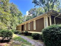 A charming single-story home featuring stone walkway and professionally landscaped yard at 4968 Twin Branches Way, Dunwoody, GA 30338