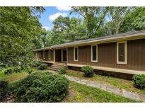 Charming home with verdant landscaping and inviting entryway at 4968 Twin Branches Way, Dunwoody, GA 30338