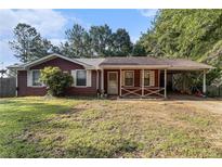Charming single story home with a covered front porch and a spacious front yard at 3953 Dalhouise Ln, Decatur, GA 30034