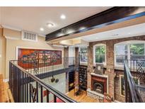 Unique living room featuring exposed brick, spiral staircase, and a mezzanine overlooking the space at 685 Argonne Ne Ave # 15, Atlanta, GA 30308