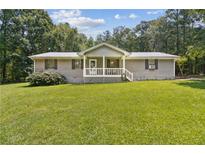 Charming single-story home with covered front porch and large front yard at 146 Pine St, Covington, GA 30014