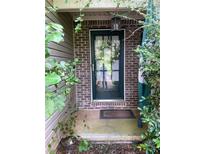 Charming front door with decorative wreath and hanging lantern, adding curb appeal to the home's entrance at 413 W Wind Dr, Villa Rica, GA 30180