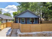 Charming single-Gathering home with a modern blue exterior and a stylish wooden fence for privacy at 85 Ollie St, Atlanta, GA 30314