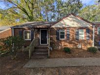 Charming brick home featuring a cozy front porch and well-maintained landscaping at 2904 Glenwood Se Ave, Atlanta, GA 30317