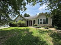 Charming single-story home with a well-manicured lawn, featuring a classic facade and inviting front entrance at 1855 Tribble Ridge Dr, Lawrenceville, GA 30045
