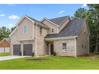 Inviting two-story home featuring a two-car garage and a mix of brick and siding at 3405 Summer Brooke Way, Union City, GA 30291
