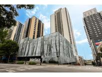 Modern high-rise building featuring sleek design and an eye-catching tree graphic at 1280 W Peachtree Nw St # 4003, Atlanta, GA 30309