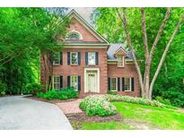 Charming brick home with manicured lawn and lush landscaping and beautiful architectural details at 1781 Point Pleasant Se, Smyrna, GA 30080