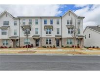 Charming townhomes featuring painted brick, private entries, and manicured front yards offer inviting curb appeal at 1273 Harvest Park Ln, Suwanee, GA 30024