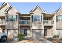 Townhome exterior showcasing private garages, entrances and upper-level balconies at 1843 Broad River Rd, Atlanta, GA 30349