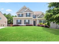 Charming two-story home with manicured lawn and lush landscaping at 405 Blue Sky Circle Cir, Acworth, GA 30102