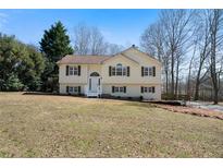 Charming two-story home with light yellow siding, dark shutters, and a well-maintained front lawn at 4312 Daniel Dr, Winston, GA 30187
