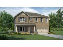 Charming two-story brick home with a well-manicured lawn and attached two-car garage at 516 Almere Dr, Hampton, GA 30228