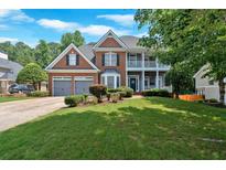 Charming two-story brick home with a well-manicured lawn, two-car garage, and balcony at 6236 Millstone Trl, Douglasville, GA 30135