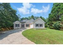 Charming single-story home featuring stone accents, fresh exterior paint and a well-manicured lawn at 75 Fox Chase, Covington, GA 30016