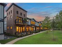 Charming brick townhomes feature landscaped front yards and cozy balconies in a warm, inviting community setting at 937 Willingham Dr # 7, Hapeville, GA 30354