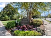 Entrance to Lakemoore Colony, a private townhome community, with beautiful landscaping and mature trees at 270 Lakemoore Ne Dr # B, Atlanta, GA 30342