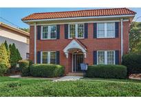 Charming brick home featuring a red tile roof, black shutters and mature landscaping at 824 Greenwood Ne Ave # 8, Atlanta, GA 30306