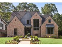 Charming brick home featuring a sophisticated modern design and manicured front lawn at 298 Saint Marys Nw Ln, Marietta, GA 30064