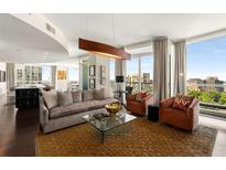 Sunlit living room with open floor plan, modern lighting, and stunning city views at 3325 Piedmont Ne Rd # 2006, Atlanta, GA 30305