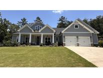Charming craftsman-style home with a well-manicured lawn, stone accents, and a two-car garage at 287 Flower Farm Dr, Acworth, GA 30101