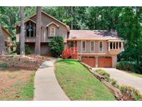 Charming split-level home with wood siding, complemented by a well-maintained landscaped front yard at 4915 Millers Trce, Peachtree Corners, GA 30096