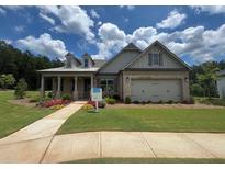 Charming single Gathering home featuring a two-car garage and welcoming covered front porch at 730 Brooke View Drive, Canton, GA 30115