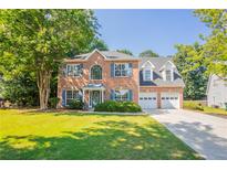 Charming two-story brick home with well-maintained lawn and a two-car garage at 2346 Hampton Park Dr, Buford, GA 30519