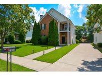 Charming brick two-story home with a well-manicured lawn and lovely landscaping at 3332 Chastain Landings Ct, Marietta, GA 30066
