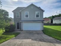 Charming two-story home featuring a two-car garage, stone accents, and a well-manicured lawn at 378 Durmire Dr, Jonesboro, GA 30236