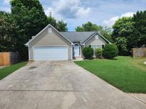 Charming single-Gathering home with a well-maintained front yard and a two-car garage at 535 Village Cir, Stockbridge, GA 30281
