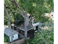 A lush, tree-filled canopy surrounds this charming home with a porch and balcony, offering privacy and a tranquil setting at 770 Barnett Street Northeast Ne St, Atlanta, GA 30306