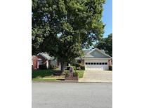Charming single-story home with a two-car garage, brick mailbox, and mature trees in a quiet neighborhood at 1875 Conners Ct, Lawrenceville, GA 30044
