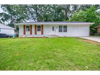 Charming single-story home with a well-maintained lawn and mature trees in a desirable neighborhood at 766 Brian Ln, Forest Park, GA 30297