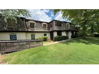 Charming townhome featuring a well-maintained lawn and inviting entrance, perfect for comfortable living at 50 Le Parc Fontaine, Lithonia, GA 30038