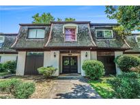 Charming condo featuring unique architectural details and a welcoming front entrance and mature landscaping at 50 Le Parc Fontaine, Lithonia, GA 30038