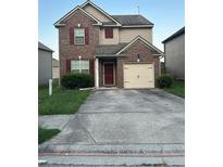 Two-story brick home with a attached one car garage and a well-manicured lawn at 5752 Little River Rd, Atlanta, GA 30349
