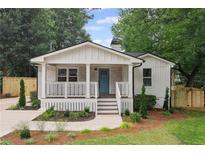 Charming craftsman-style home with a welcoming front porch and blue front door at 942 Mclinden Se Ave, Smyrna, GA 30080
