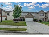 Charming two-story home with a well-manicured lawn and attached two car garage at 1767 Weatherbrook Cir, Lawrenceville, GA 30043