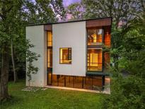 Modern home with large windows, wood accents, and lush greenery surrounding the property at 2105 Fairhaven Ne Cir, Atlanta, GA 30305
