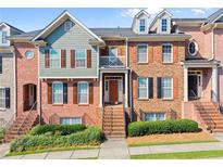 Attractive brick townhome featuring a well-maintained landscape and a charming exterior staircase at 2345 Gallard St, Lawrenceville, GA 30043