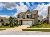Charming two-story home with landscaped front yard and attached two-car garage in a suburban neighborhood at 2486 Bear Mountain St, Lithonia, GA 30058